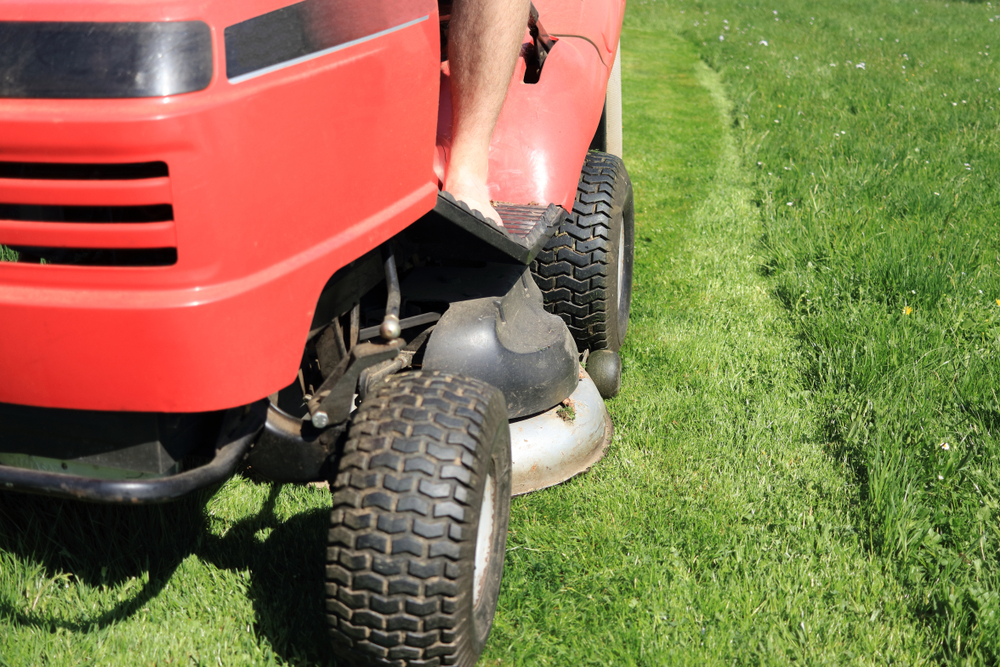 Closeup of a lawn mower's front, including the cutting deck.