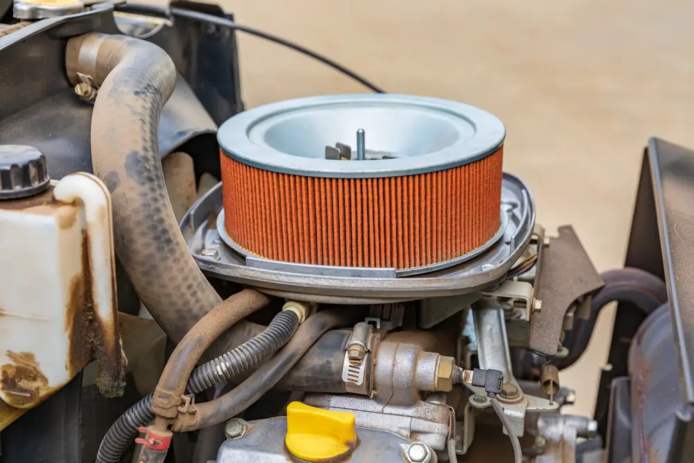 Closeup of an air filter on a lawn mower.