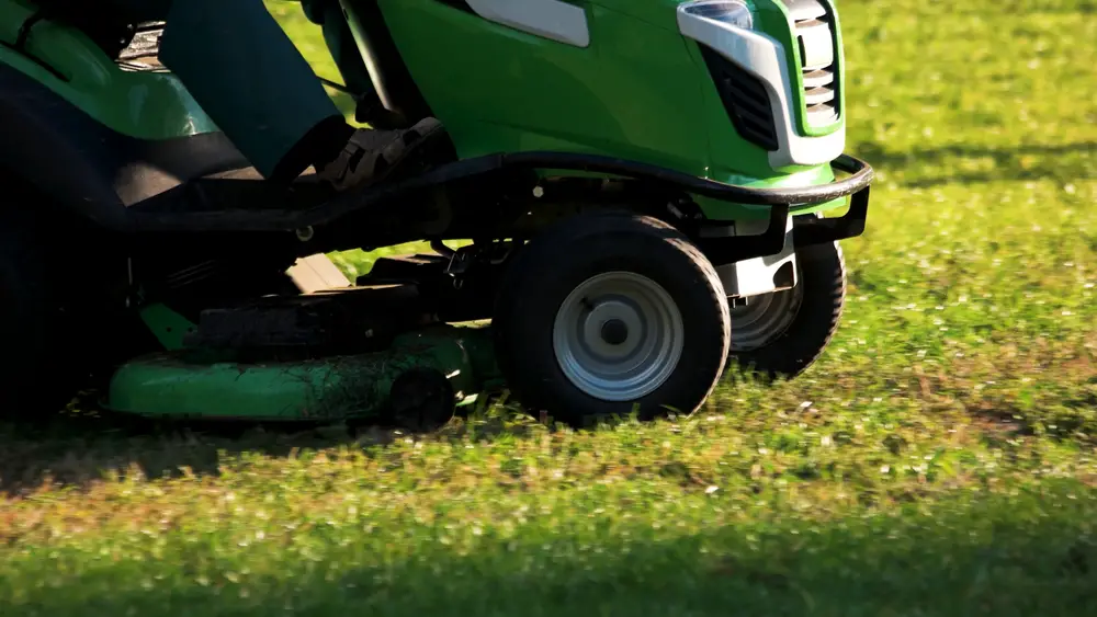 Closeup of a John Deere riding lawn mower.