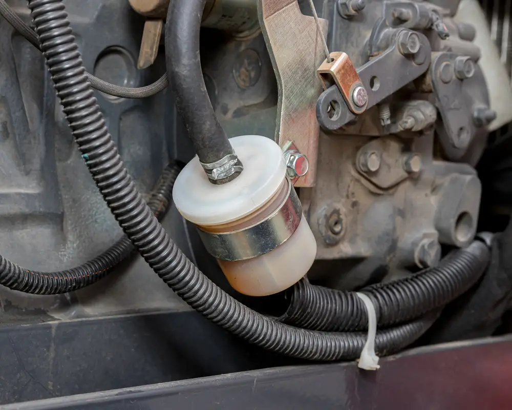 Closeup of a fuel filter on a machine.