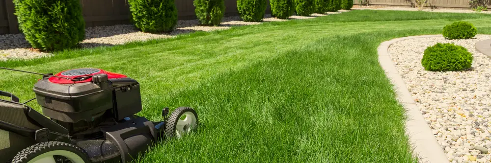 Lawn mower about to continue cutting perfect lines through a lawn.