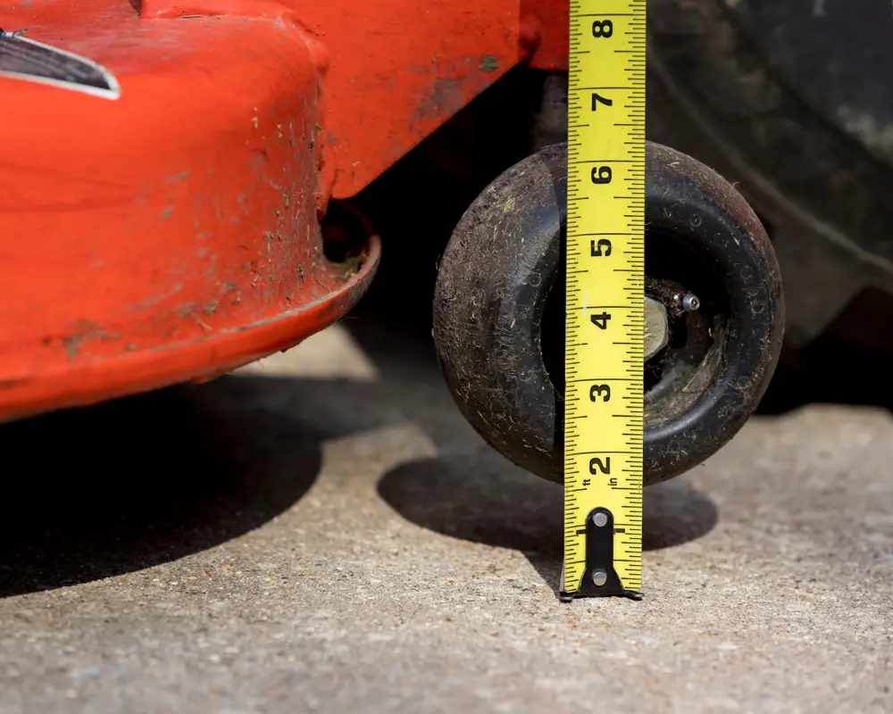 Measuring the cutting height of a lawn mower.