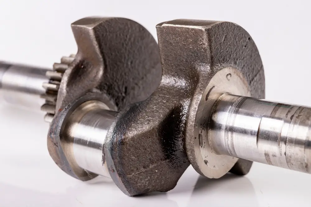 Small engine crankshaft on a white background.